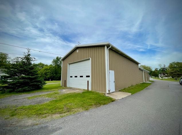 Brown metal garage with white door