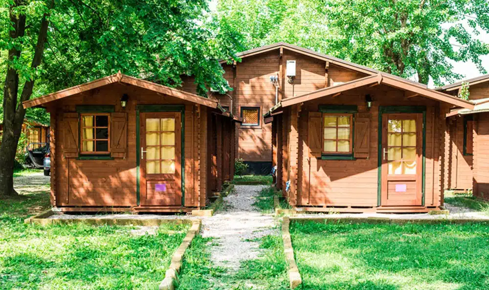 Wooden cabins in green setting