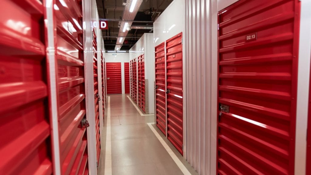 Storage unit hallway with red doors